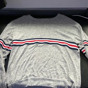 gray long sleeve shirt w/ blue, white, and red decal